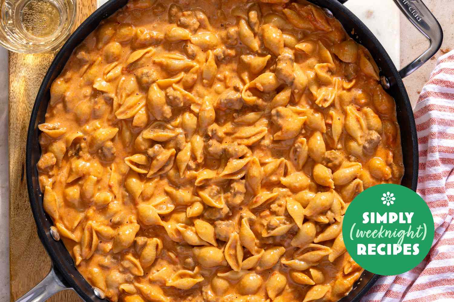 A pan of creamy pasta shells with a Simply Recipes logo overlay