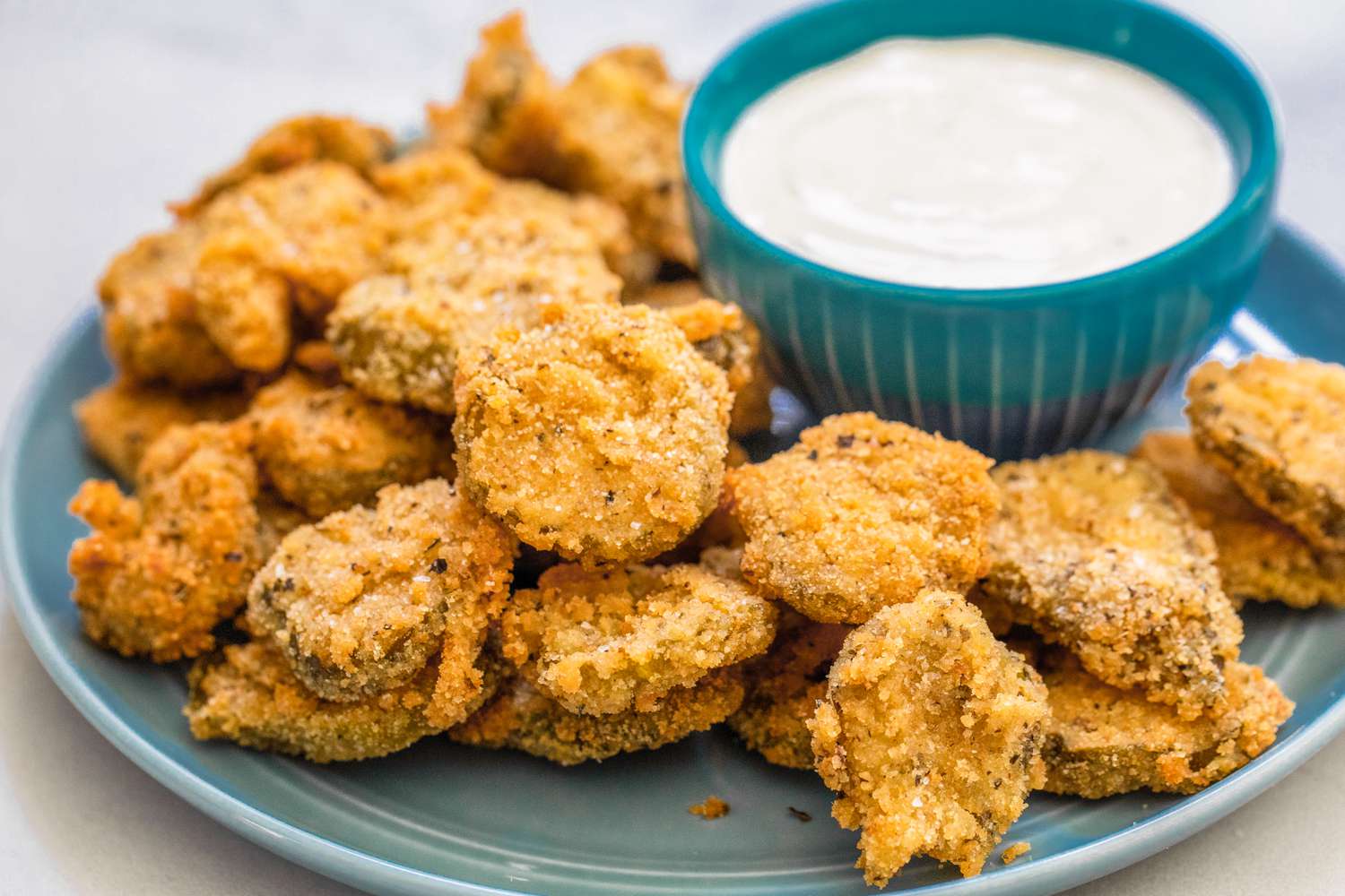 Plate of Fried Pickles Served with a Bowl of Dressing