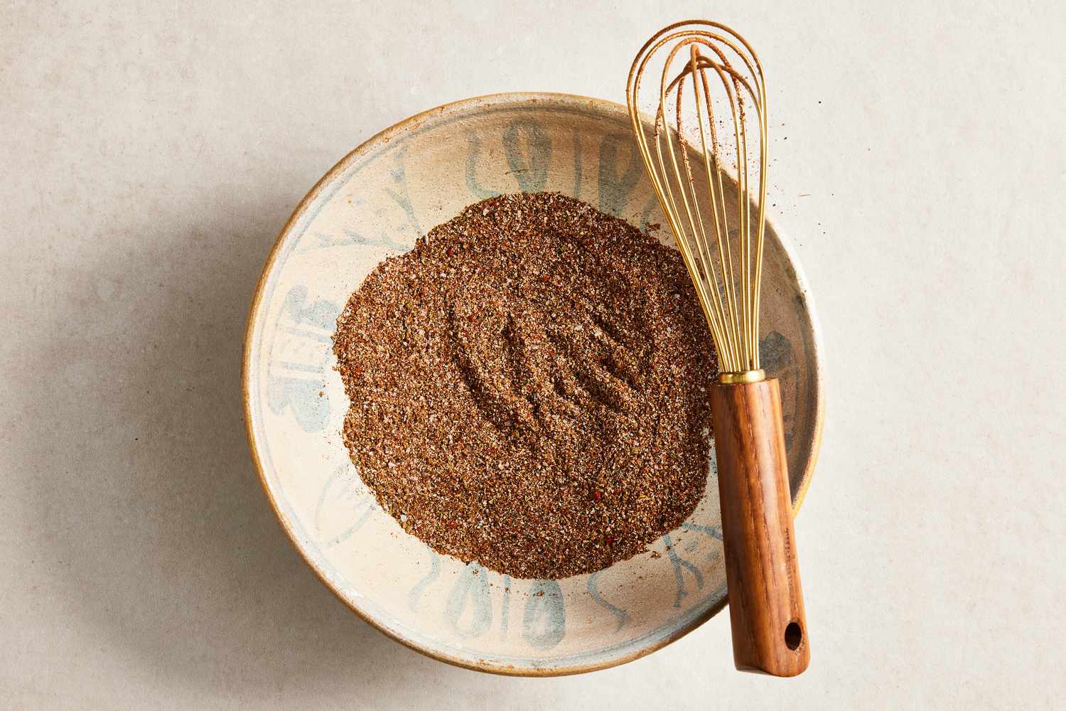 Bowl of Fajita Seasoning After Whisked Together, and Leaning on Top of the Bowl, a Whisk 