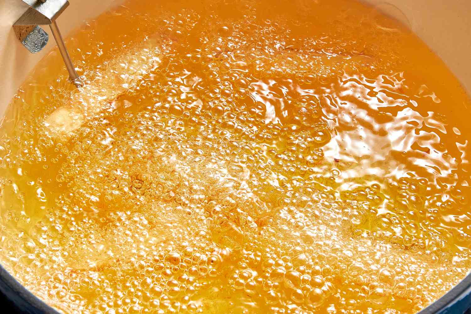 Yuca Wedges Frying in a Dutch Oven Filled With Hot Oil