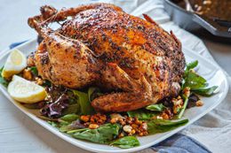 Feta-brined roast chicken on a bed of greens