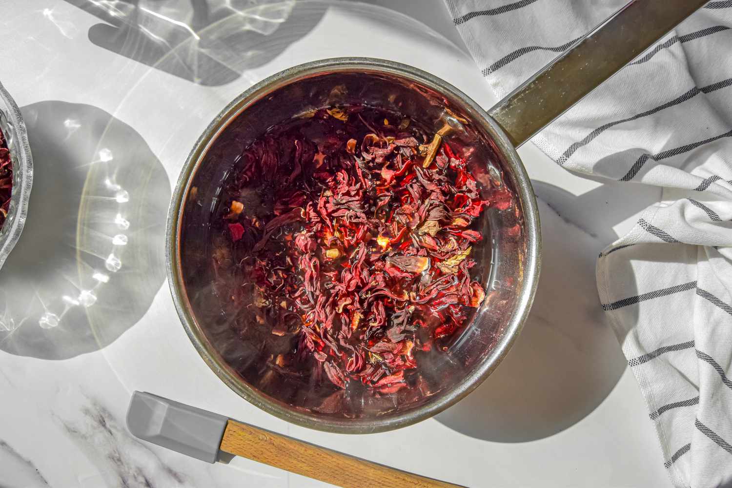 Dried Jamaica Flowers Added to Pot of Hot Sweetened Spiced Water for Agua de Jamaica Recipe