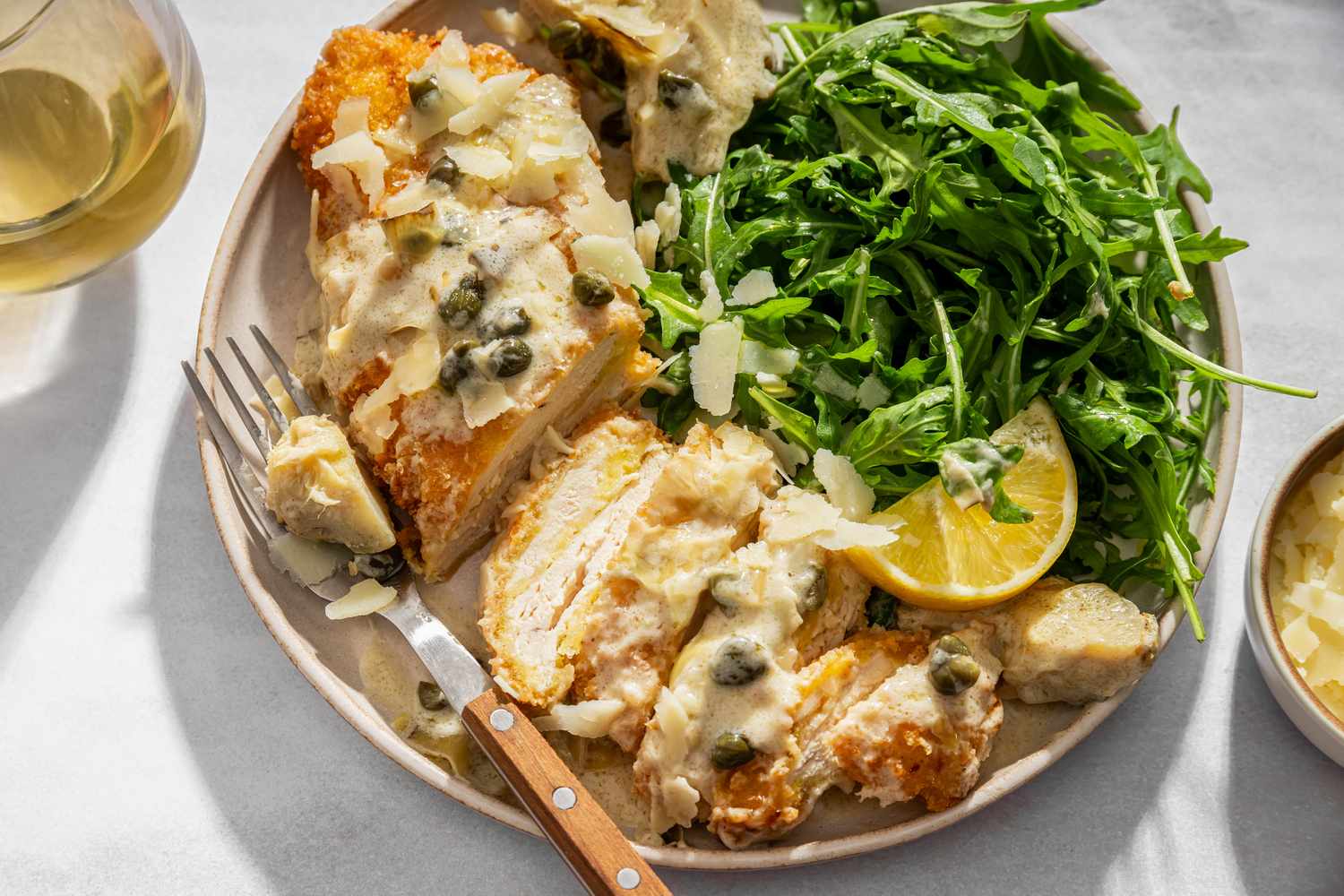 overhead view of a serving of Lemon-Artichoke Chicken Piccata served with arugula