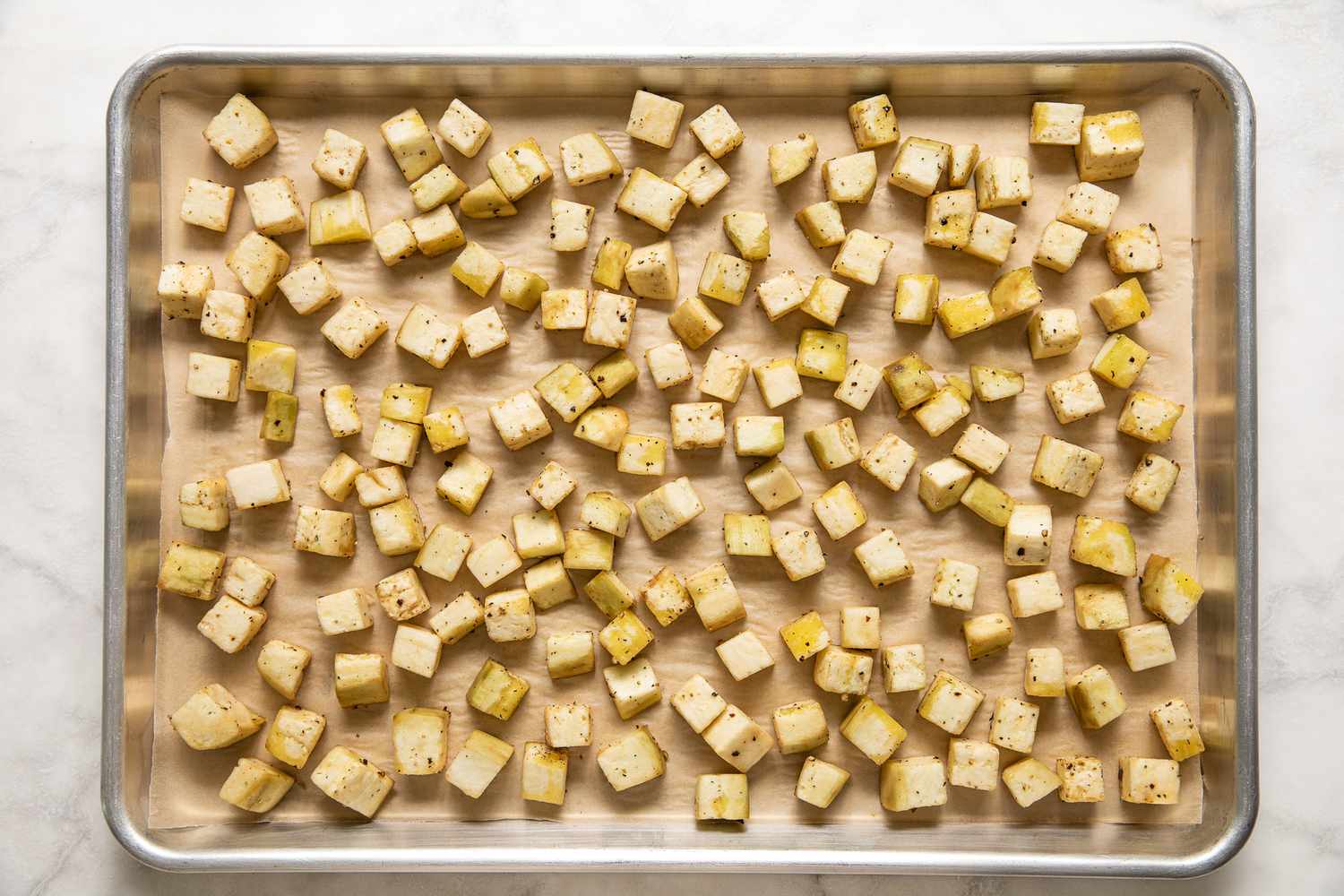 Cubed Eggplant Spread on a Parchment Lined Baking Tray