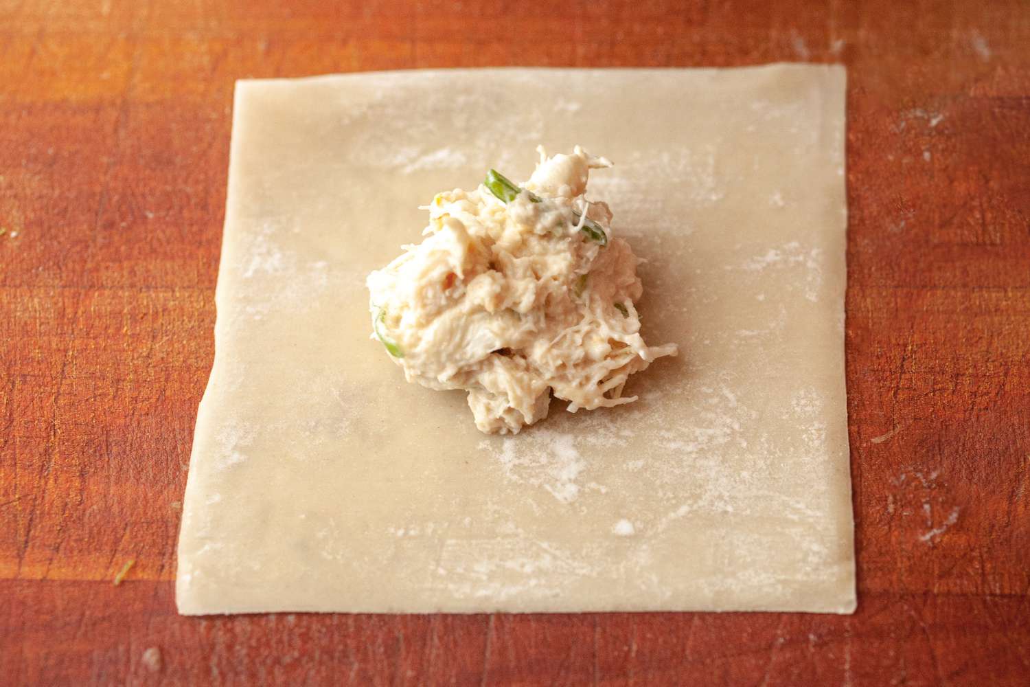 Filling a wonton wrapper for crispy homemade air fryer wontons