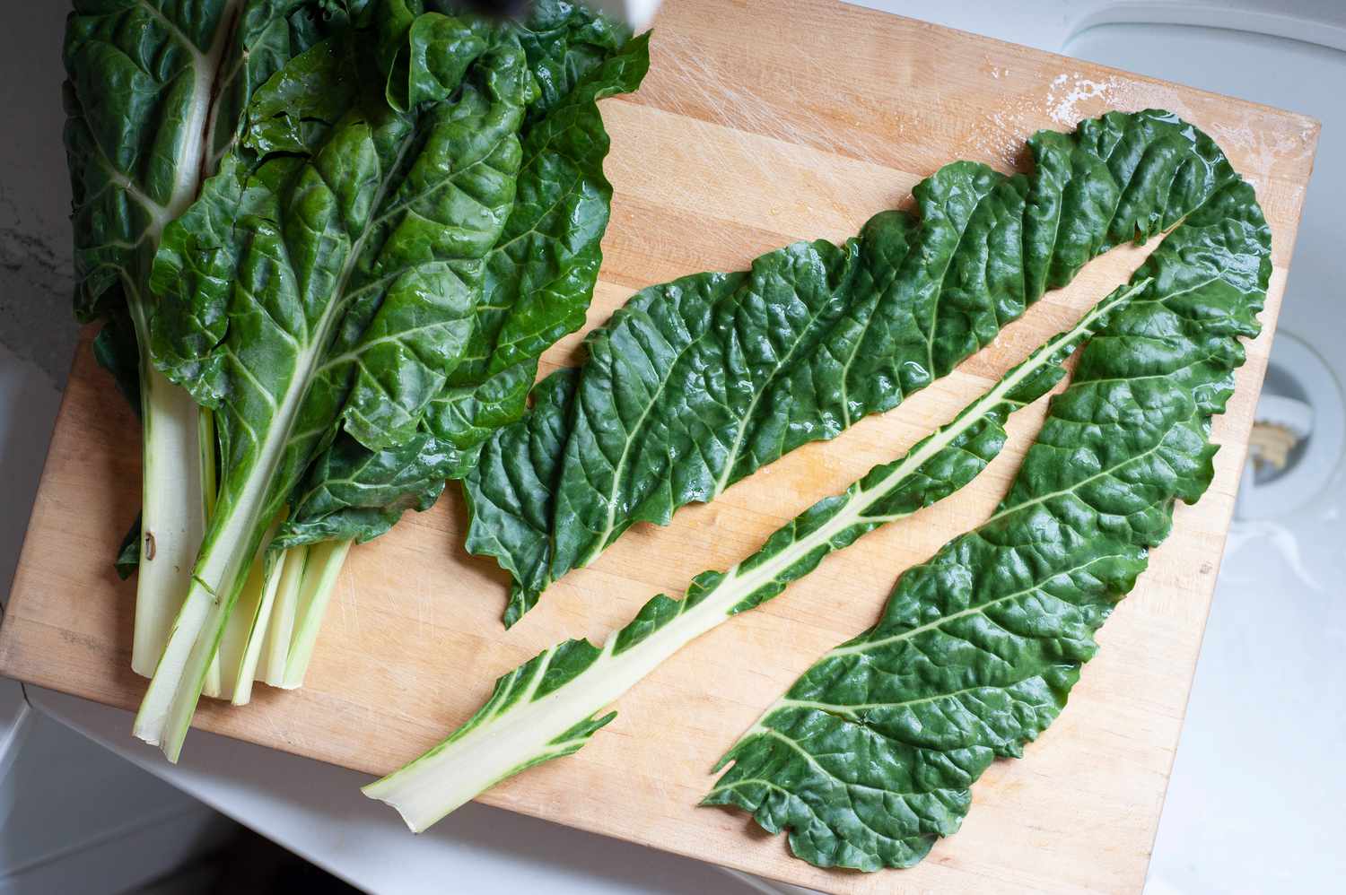 Cutting the stem out of swiss chard to make a lemony swiss chard sauce pasta.