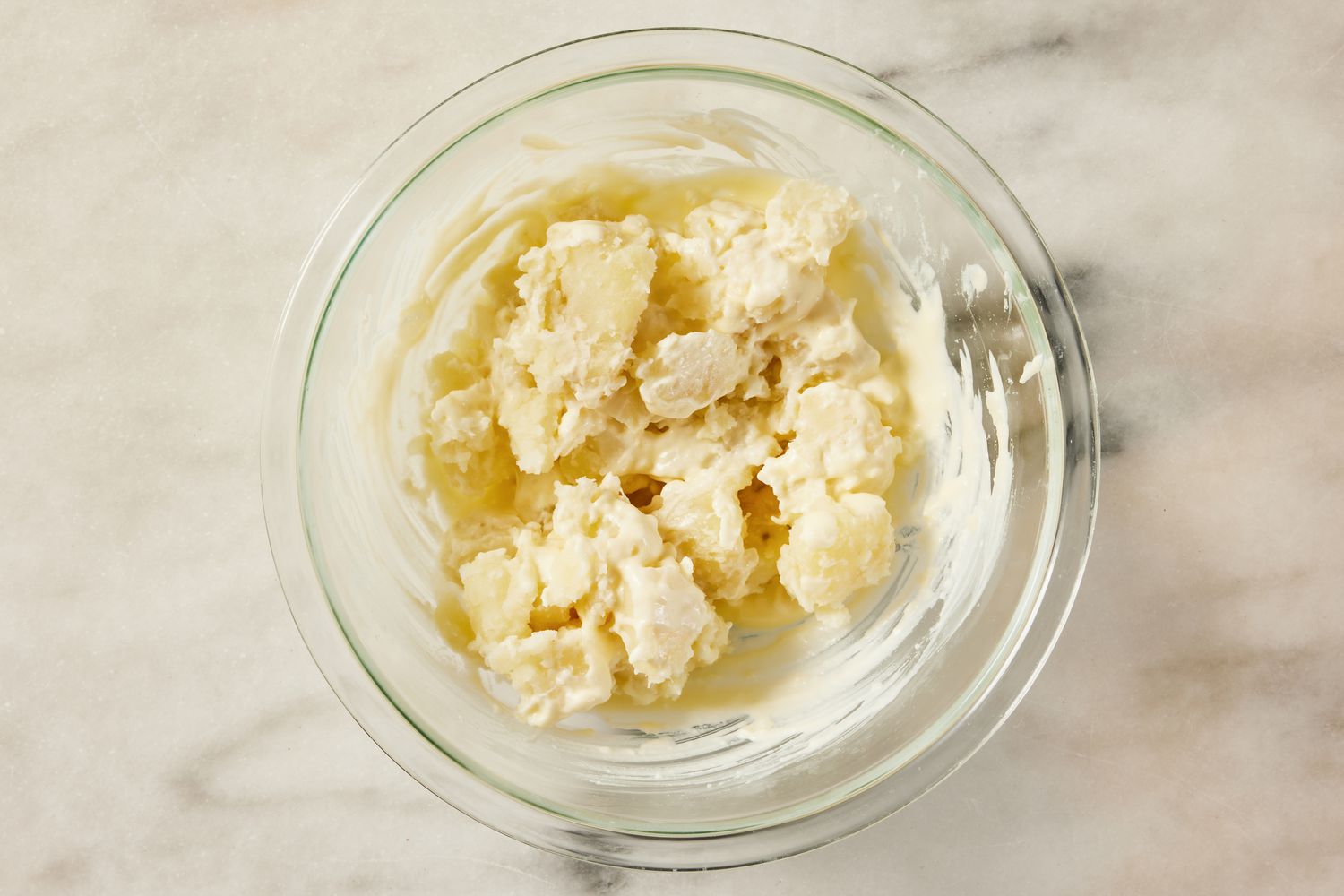 potatoes added to bowl of mayo for Korean-style potato salad recipe