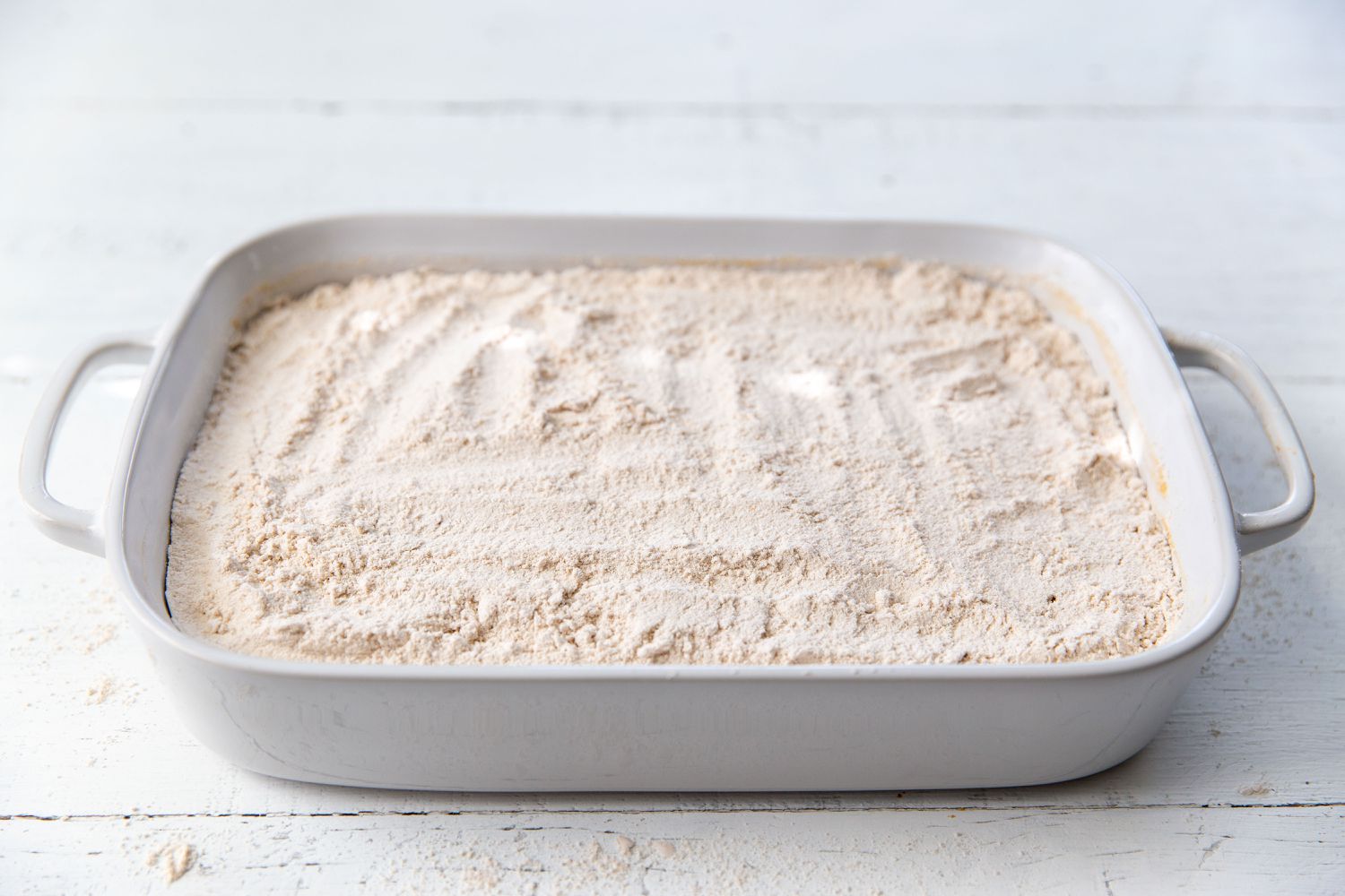 cake mix added to the top of the mixture in the baking dish for Pumpkin Dump Cake