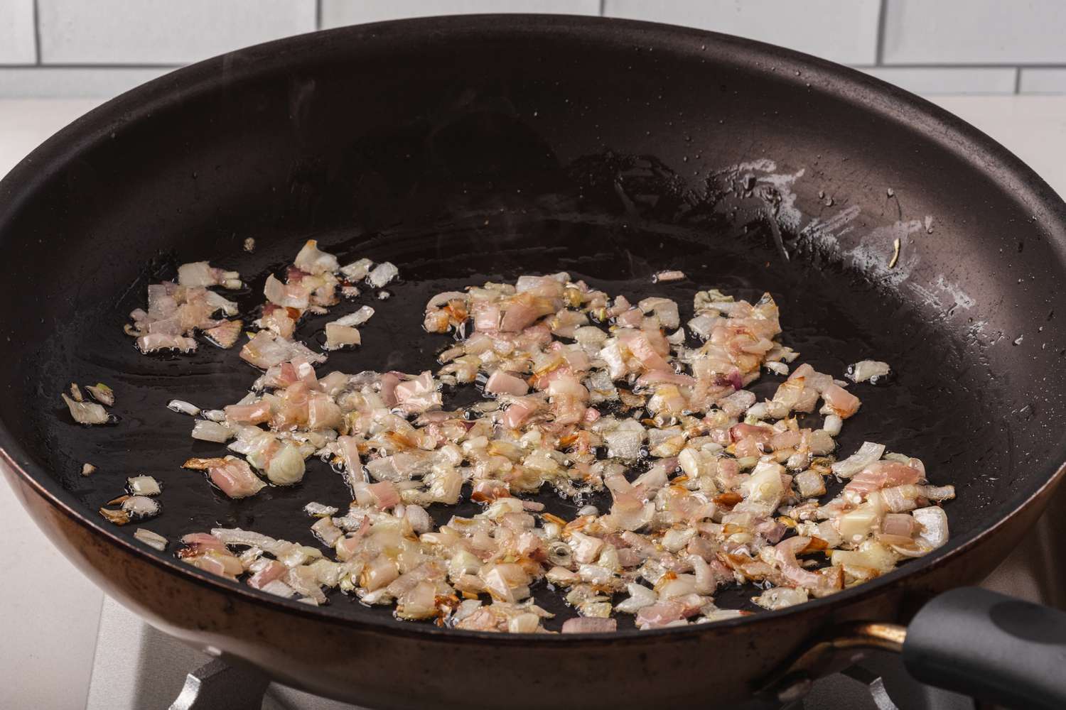 Sauteeing onions to make an easy chicken marsala recipe.