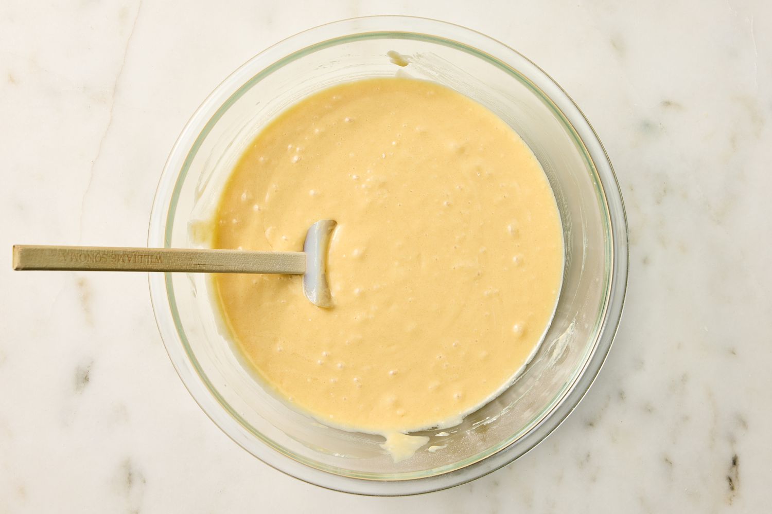 A bowl of vanilla cake batter with a spatula from Easy Vanilla Cake recipe