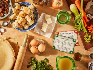 Thanksgiving meal prep scene with a pie in process and ingredients for making stuffing