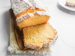 Coconut Pound Cake on cutting board, sliced.