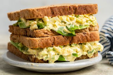 Two egg salad sandwiches stacked on top of each other