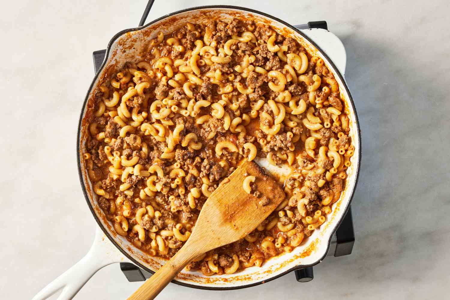 homemade hamburger helper in a skillet after slurry is added 