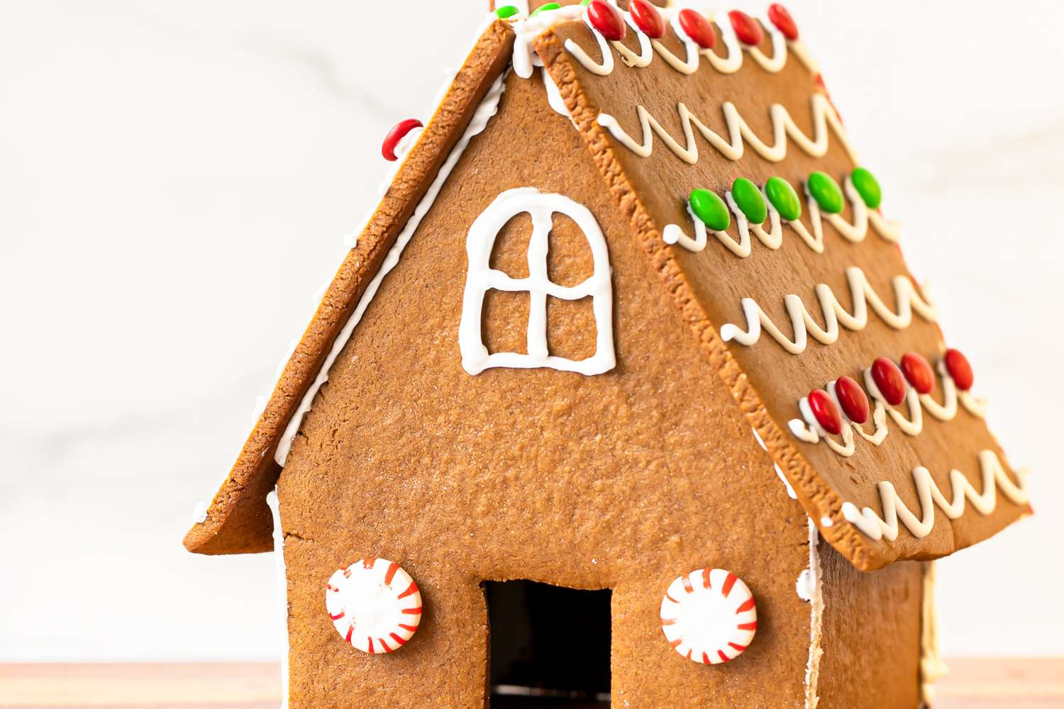 A decorated gingerbread house from a gingerbread house recipe.