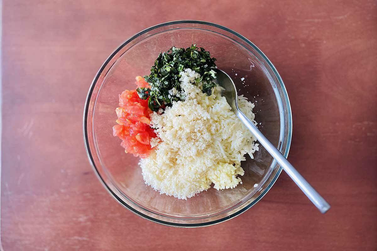 The filling for vegetarian stuffed tomatoes are in a bowl.