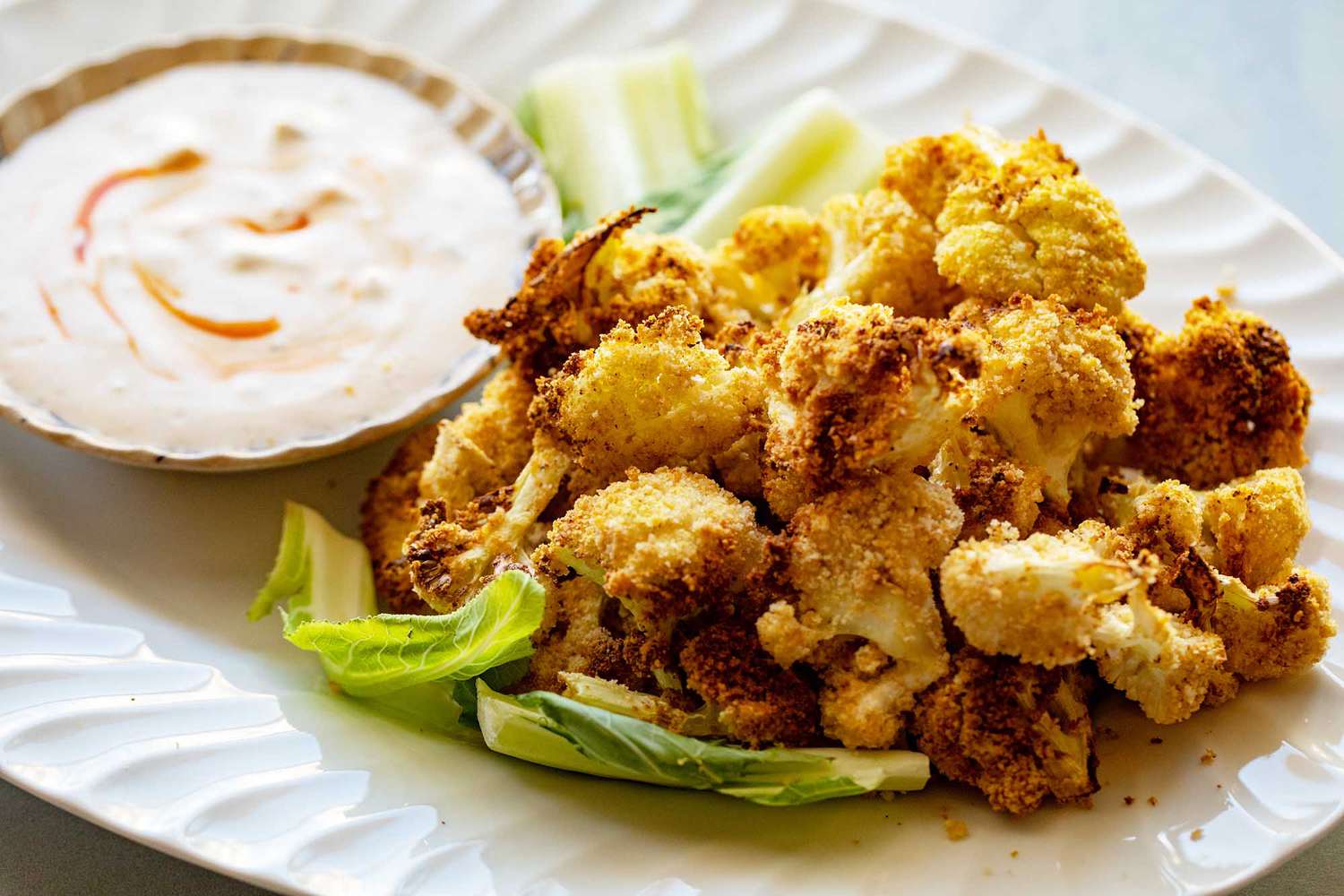 A plate of air fried cauliflower with dip, ready to be served