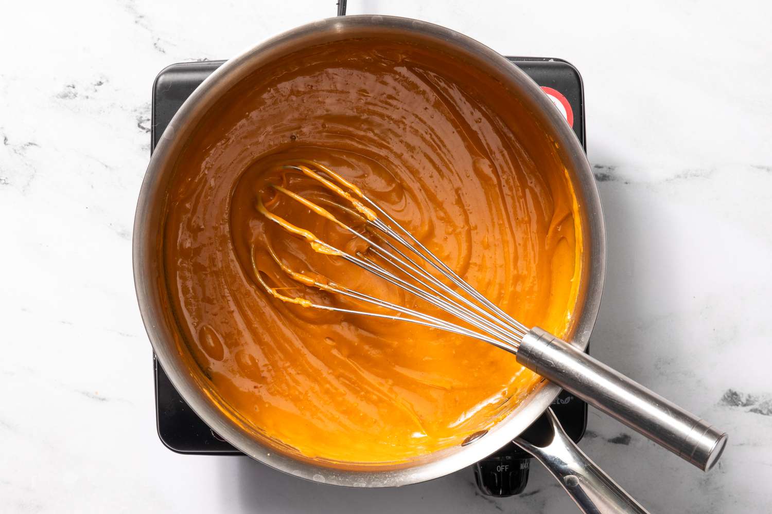Welsh rarebit cheese sauce in a pot after egg yolk is mixed in