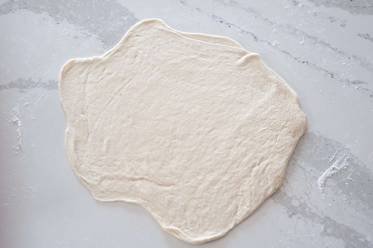 Roll out pizza dough.