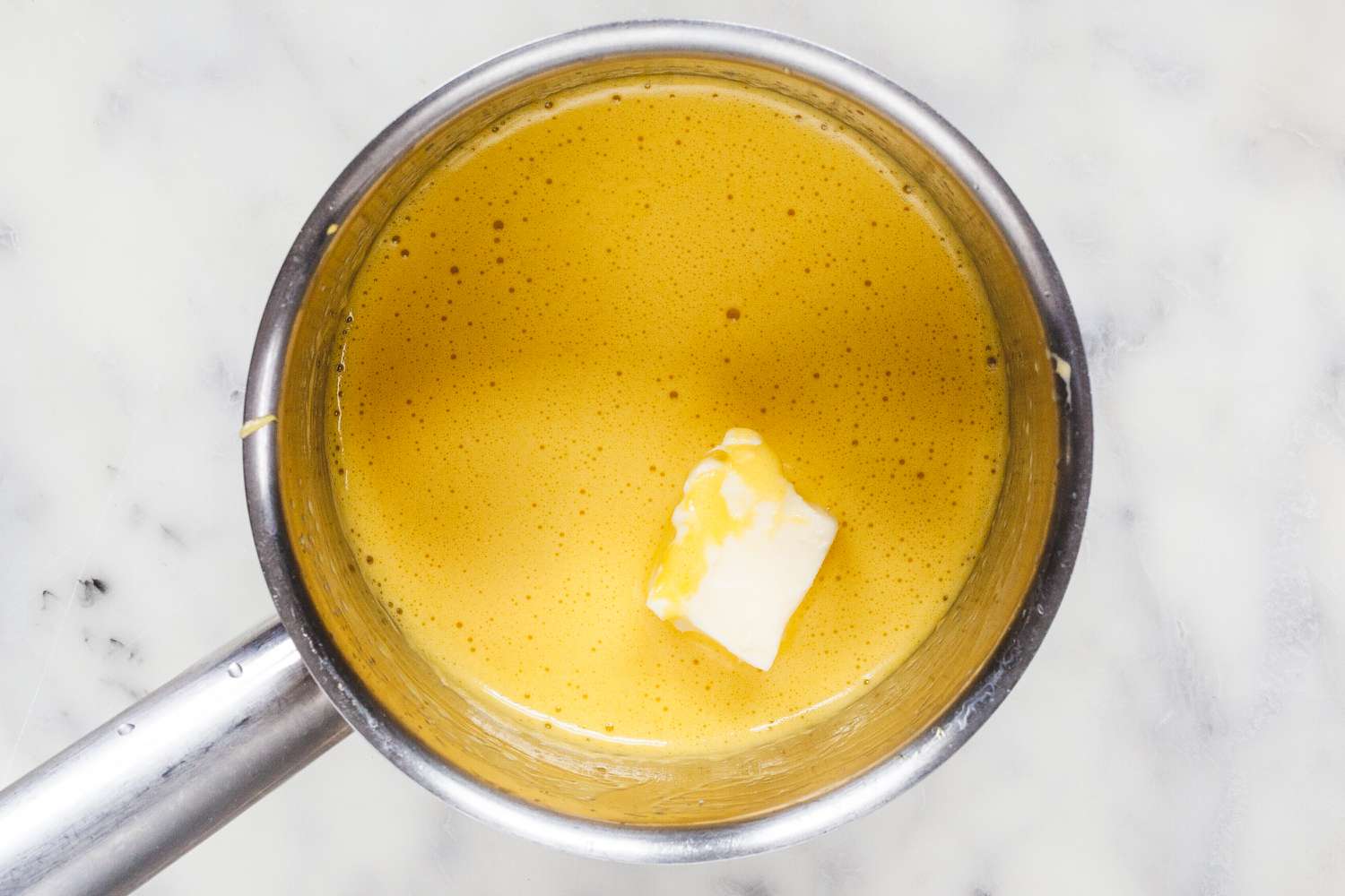 Butter added to a saucepan to make Stovetop Hollandaise Sauce.