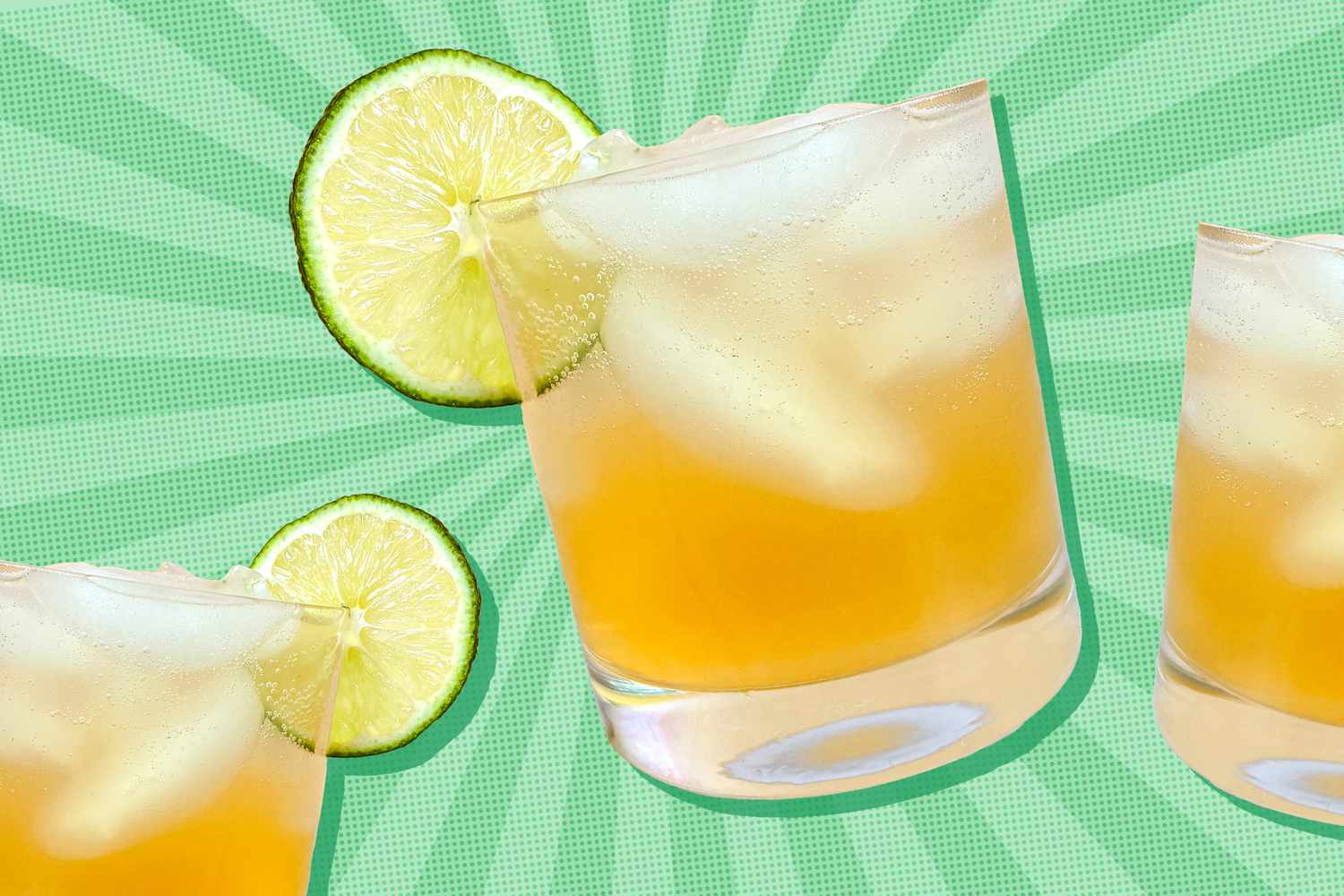 A summer cocktail in a glass with ice and a lime slice on the side
