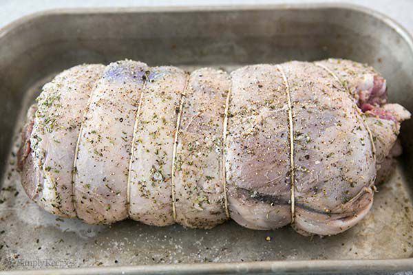Seasoned roast leg of lamb ready for baking