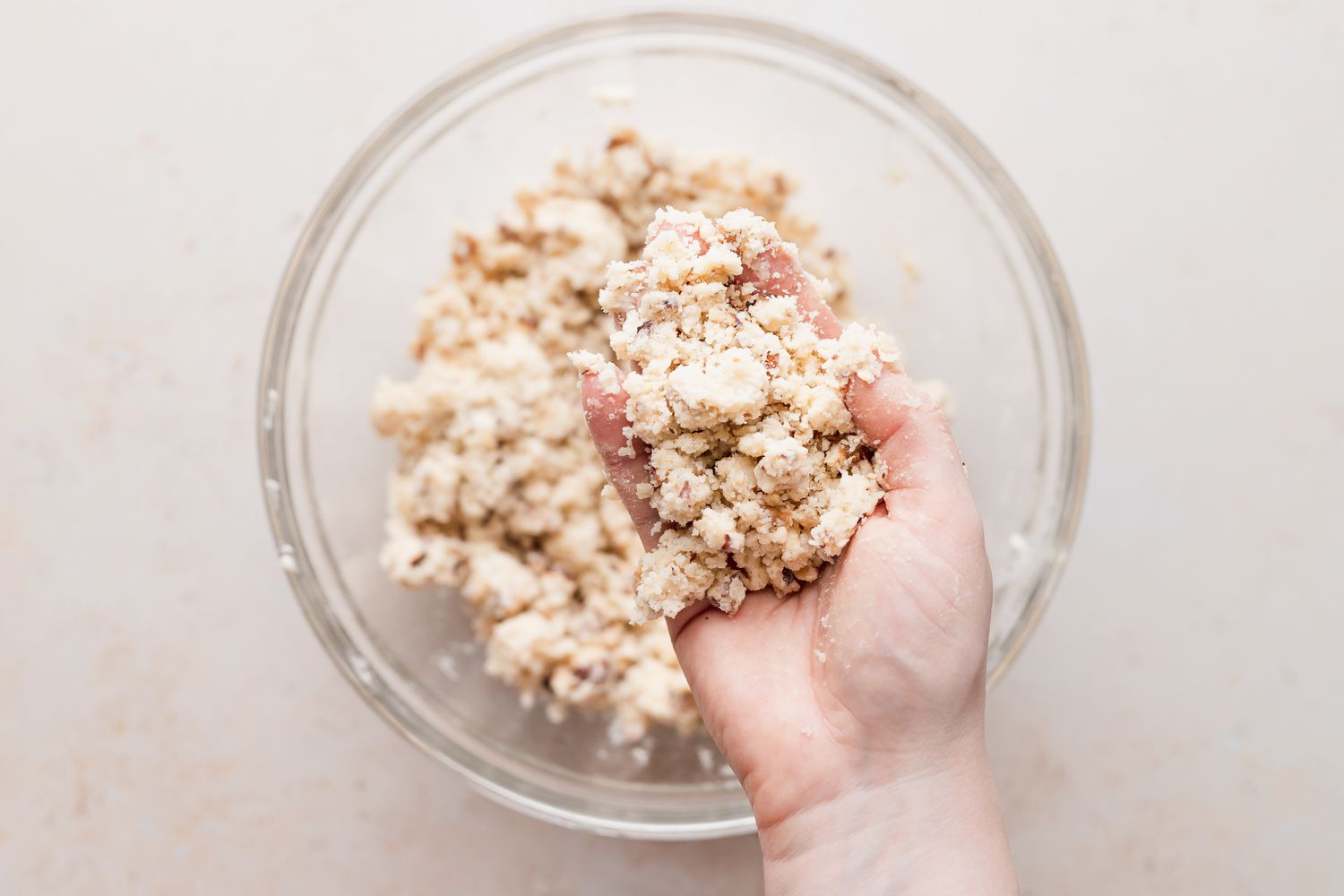 Cutting the butter into the dry ingredients to make a snowball cookie recipe.