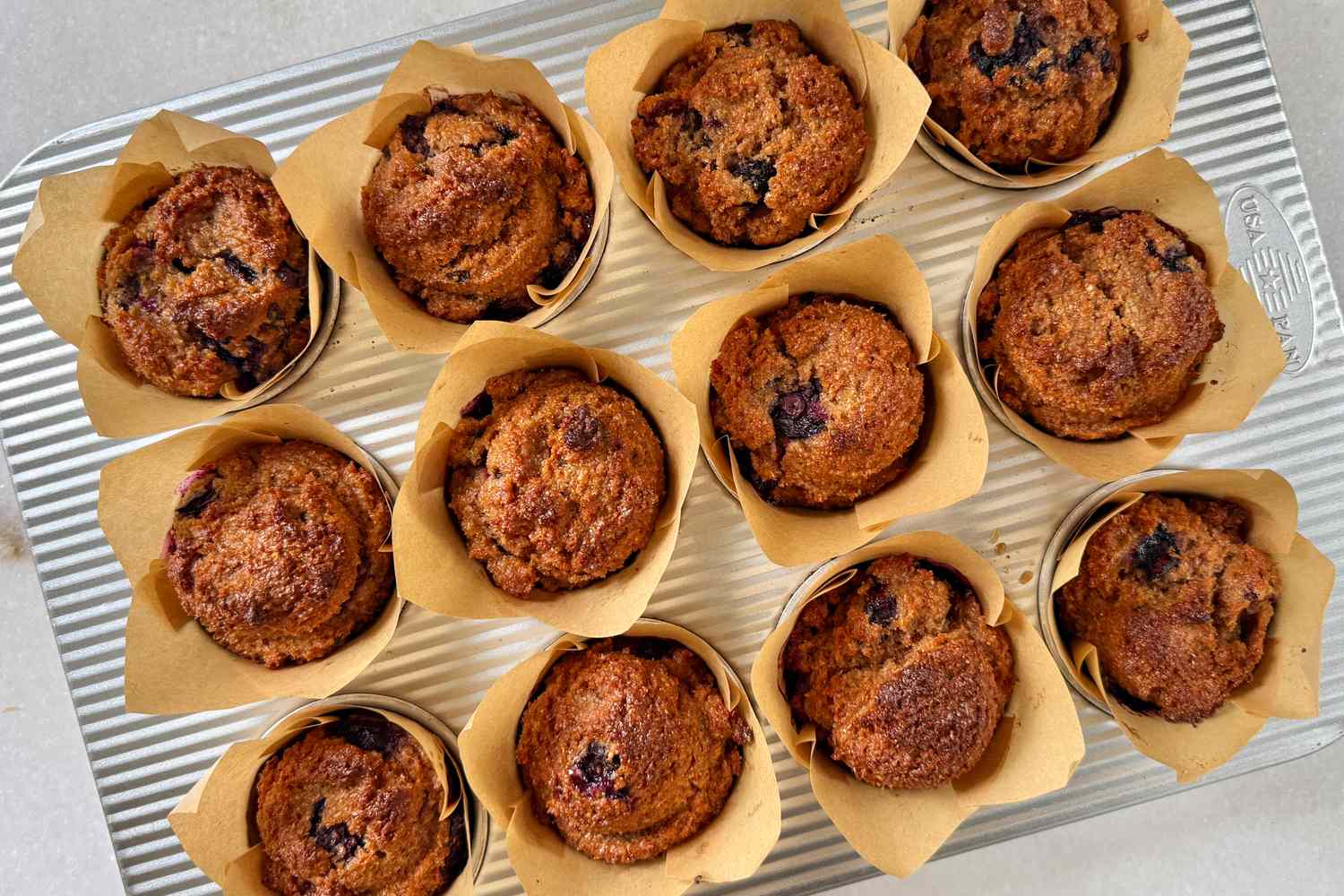 Tray of baked muffins in paper liners