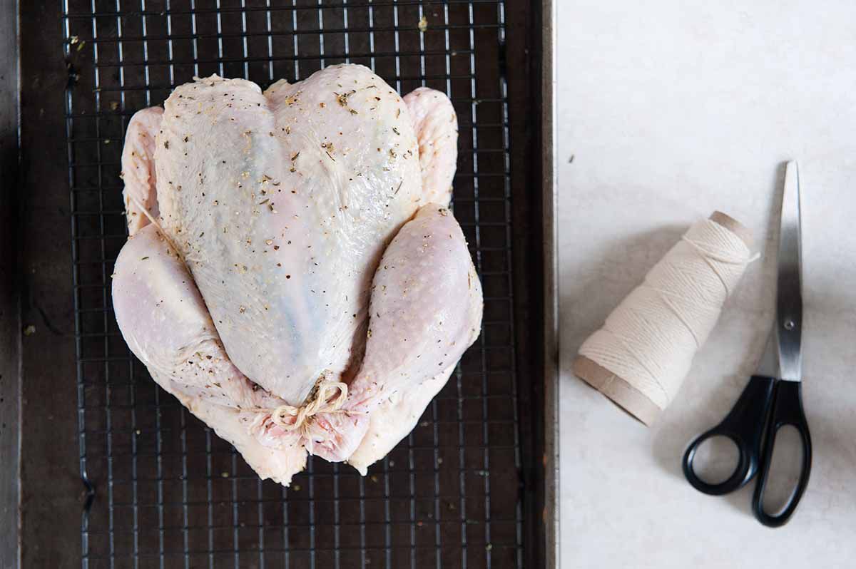 How to Roast a Whole Chicken - raw whole chicken and butchers twine