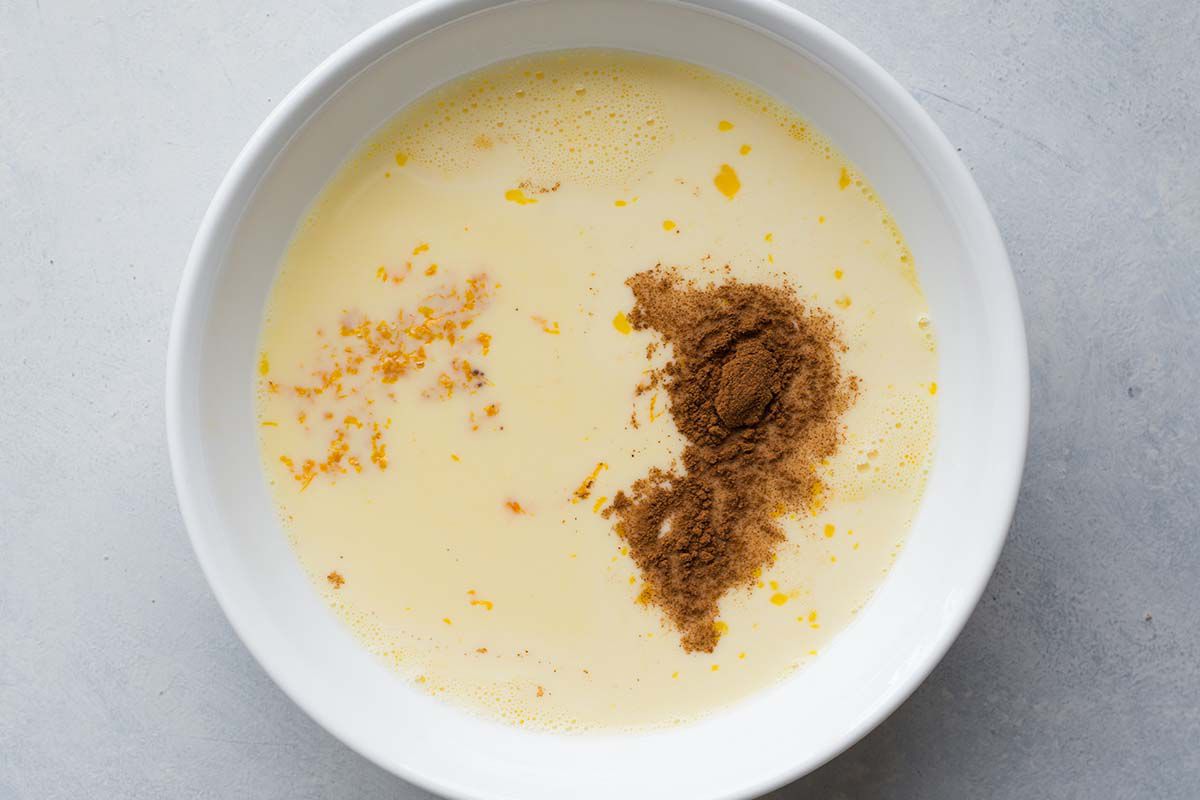 Beaten eggs, milk, and cinnamon in a bowl
