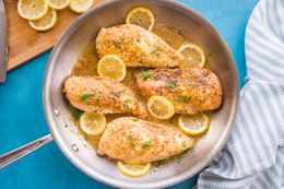 Lemon Pepper Chicken in a Pan Garnished with Shredded Parsley and Lemon Slices
