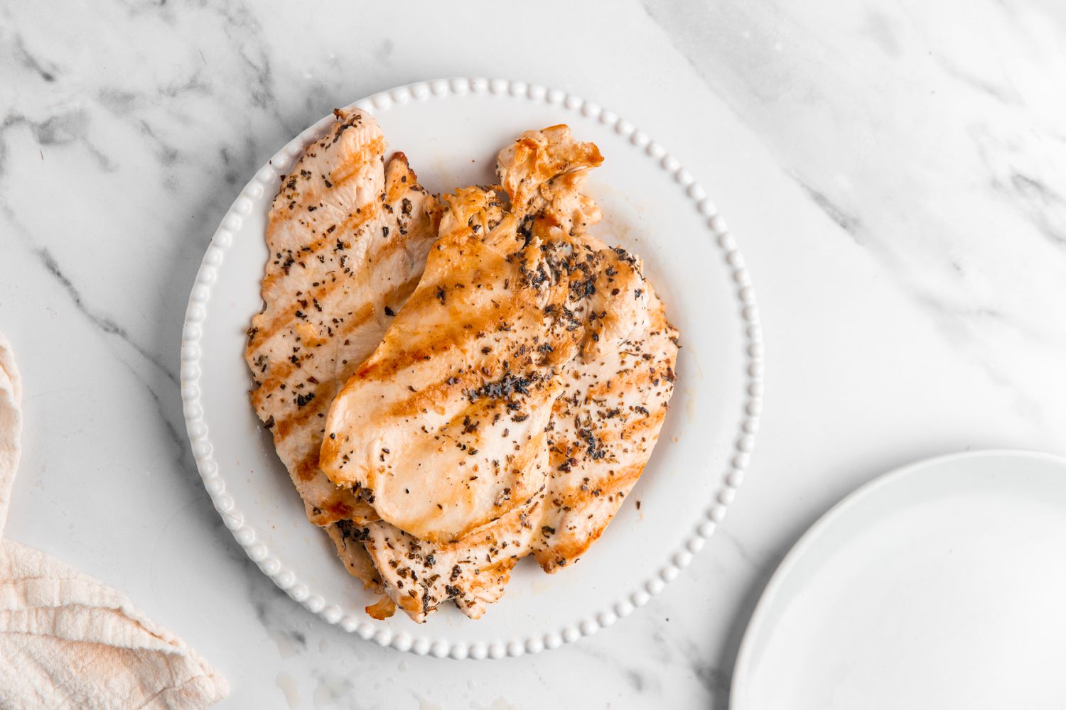 Plate With Grilled Thinly Sliced Chicken for Chicken Caprese Sandwich