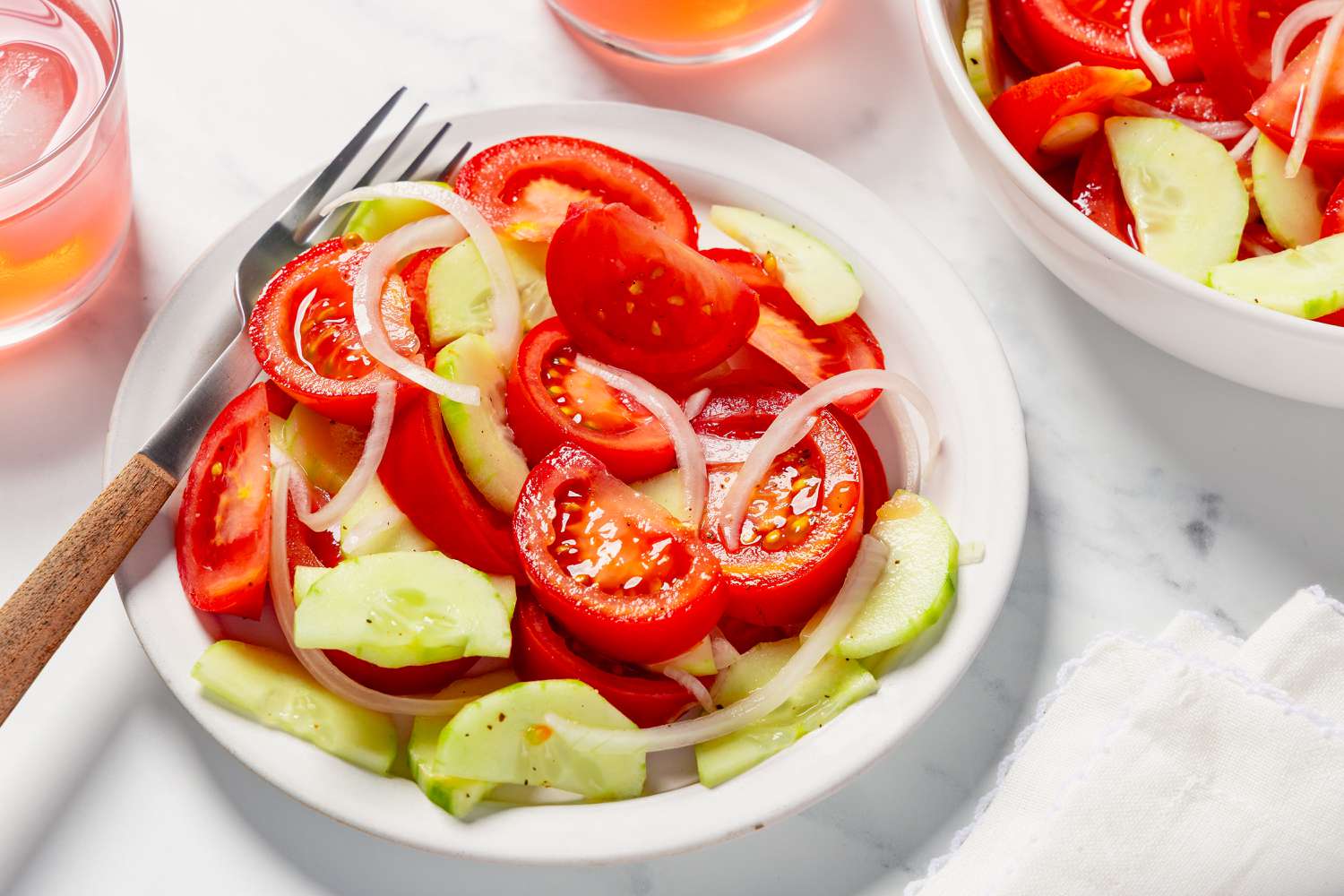 A bowl of tomato, cucumber, and onion salad
