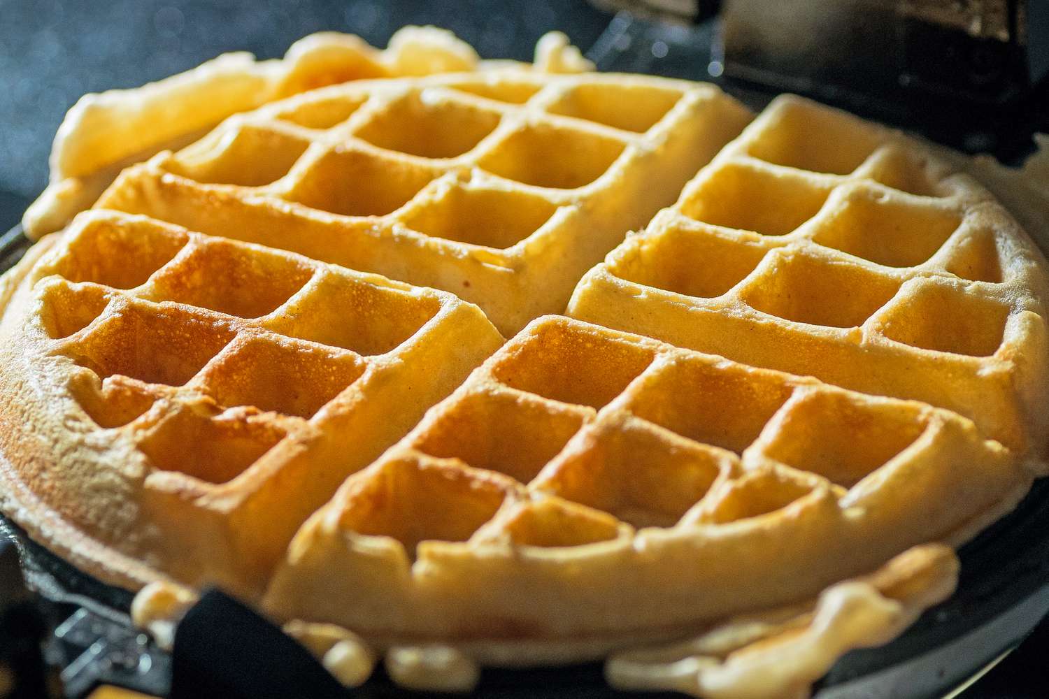 Close-up of a waffle cooking in a waffle iron