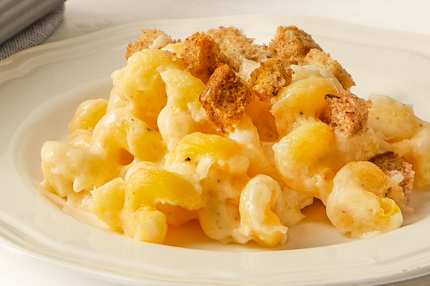 A plate of baked pasta with breadcrumbs on top