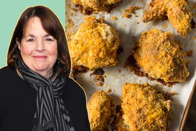 Ina Garten with a tray of baked chicken pieces