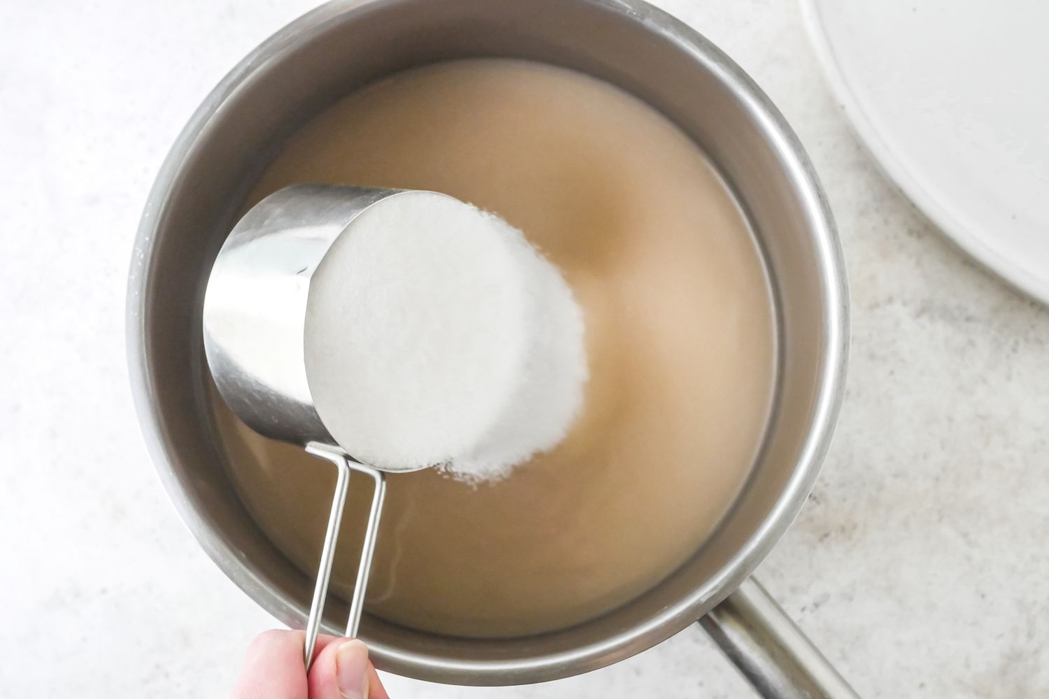 Quick and easy orgeat being made in a sauce pan.