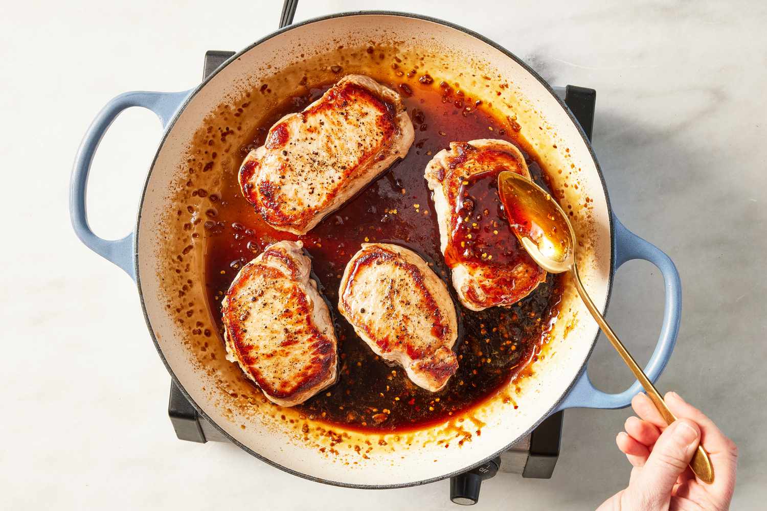 pork chops added back to the skillet and topped with the glaze glaze reduced in the wide skillet (no pork chops in the skillet) for glazed pork chops recipe