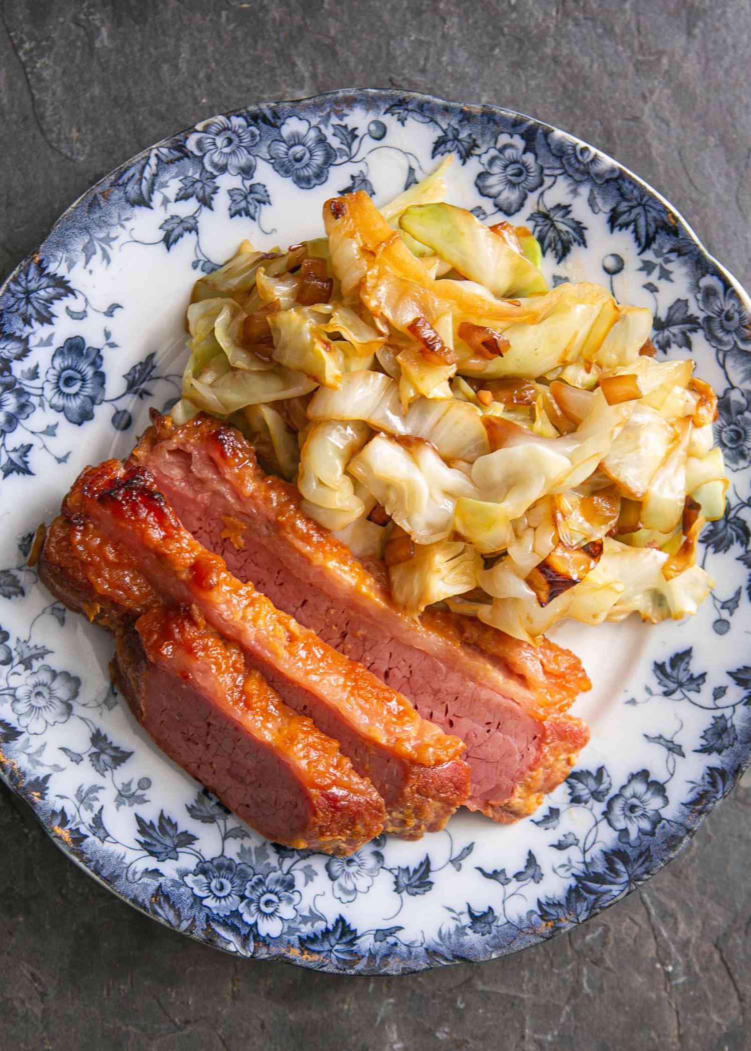 Baked Corned Beef on a plate with sauteed cabbage