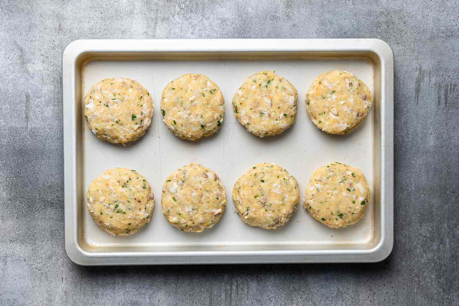 Uncooked Cod Fish Cakes on a sheet pan