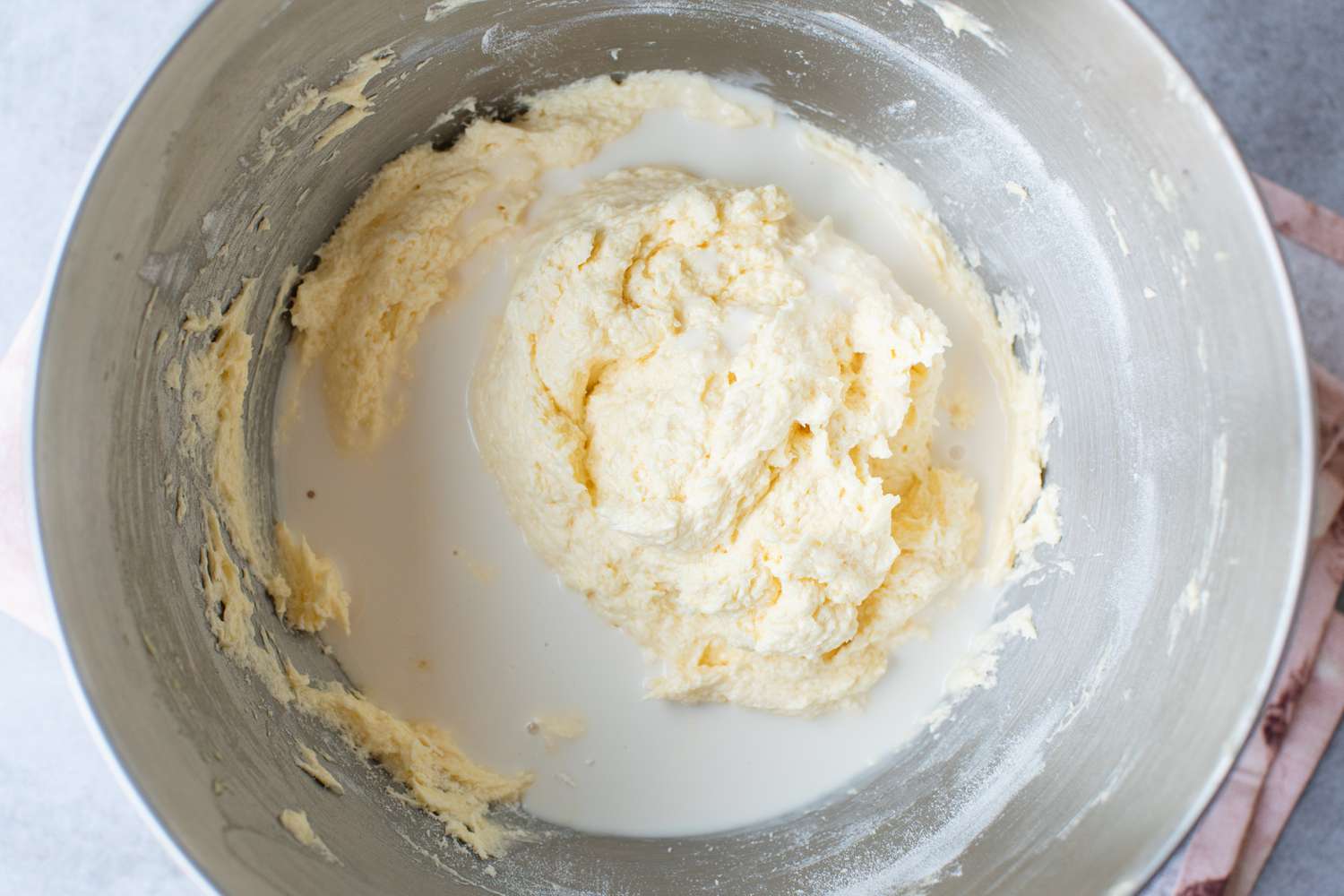 Wet Ingredients Added to Coconut Cupcakes with Coconut Cream Cheese Frosting