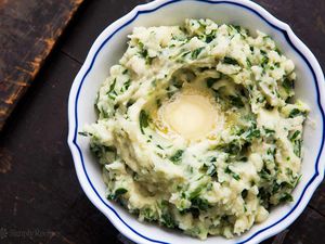 Colcannon (Irish mashed ptoatoes) in a bowl topped with butter