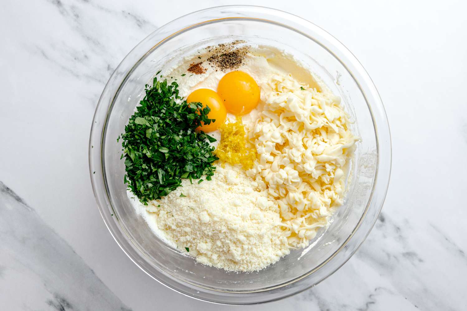 Bowl of Filling Ingredients (Parmesan Cheese, Eggs, Herbs, Mozzarella Cheese, and Ricotta) for Manicotti Recipe