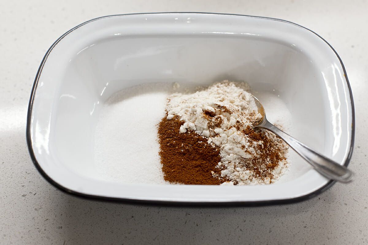Cinnamon and sugar in a bowl with a spoon