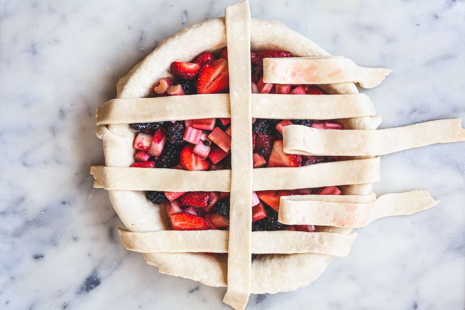 Laying strips vertically to show how to make a lattice crust.