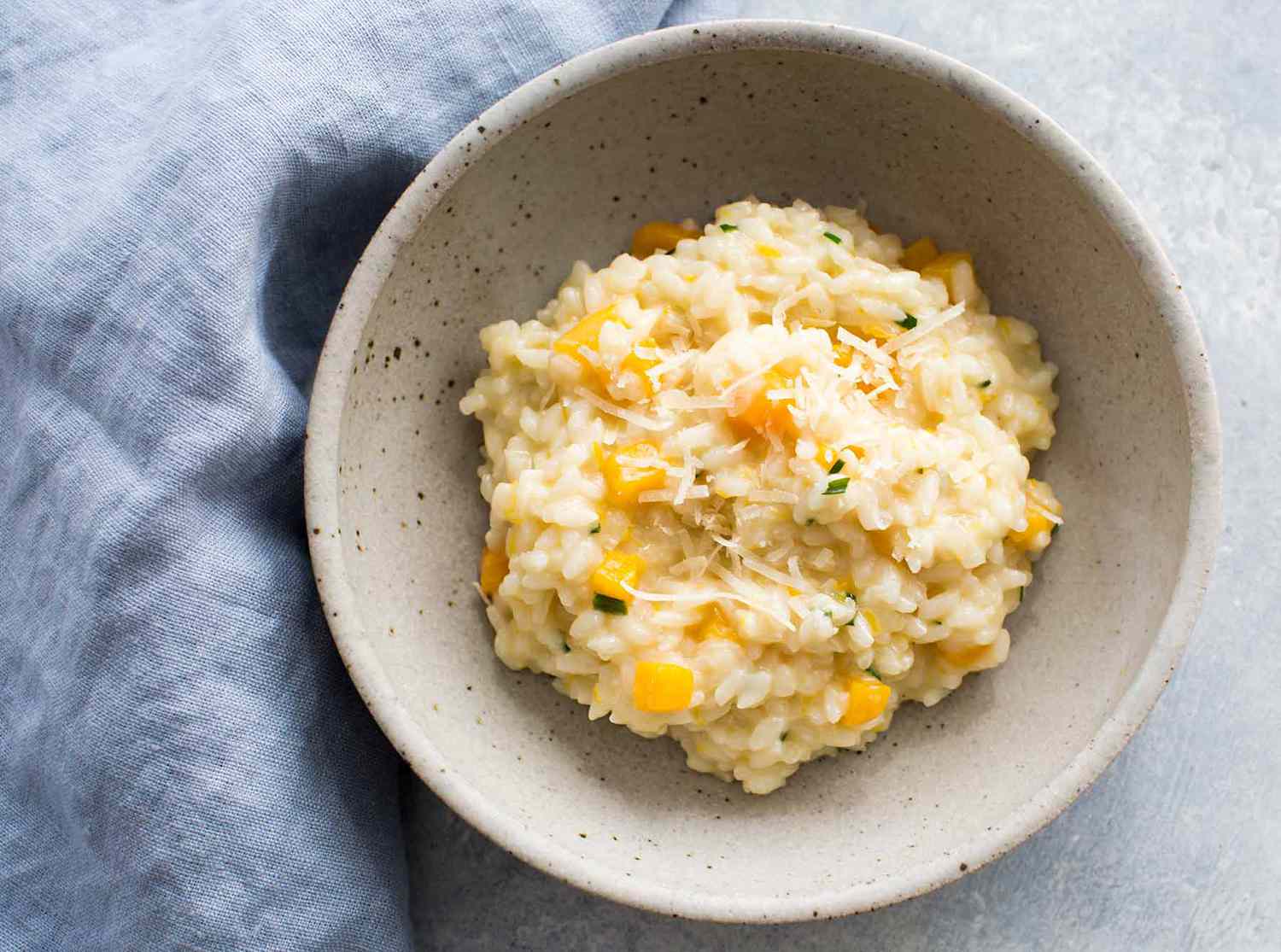 A ceramic bowl with a serving of butternut squash risotto
