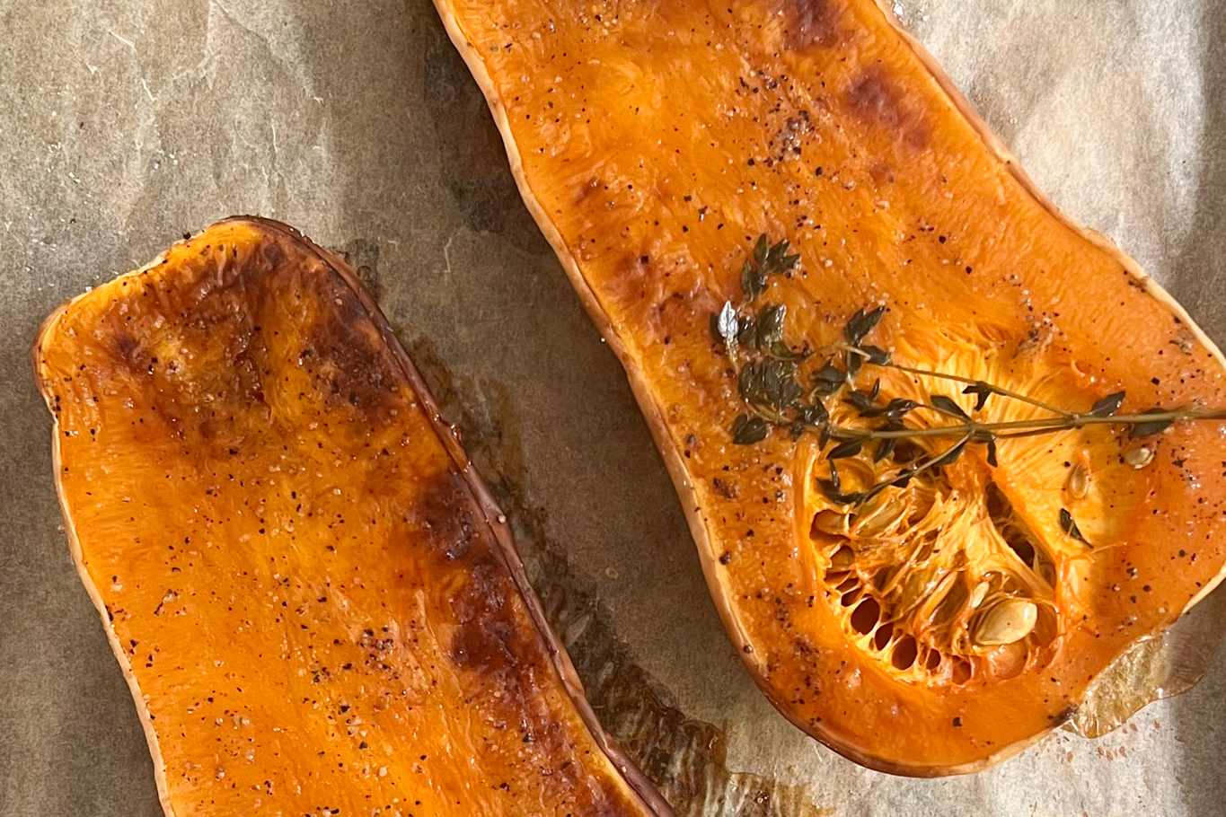 Roasted Butternut Squash on Parchment Paper Lined Baking Sheet