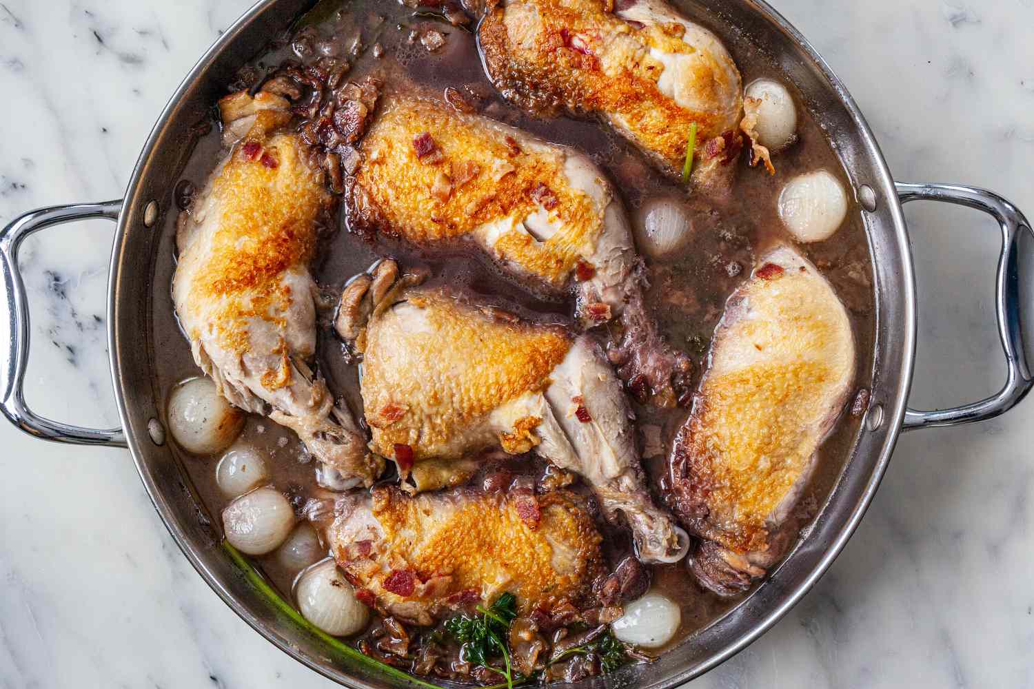 Broth and onions added to a stock pot to make cocovan.