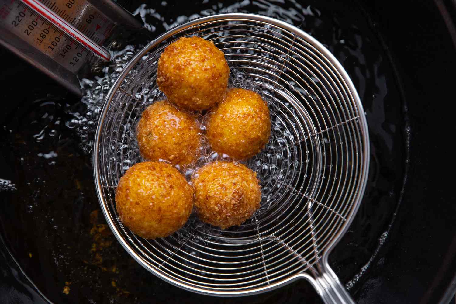 Fried Potato Croquettes Removed from Hot Oil Using a Spider