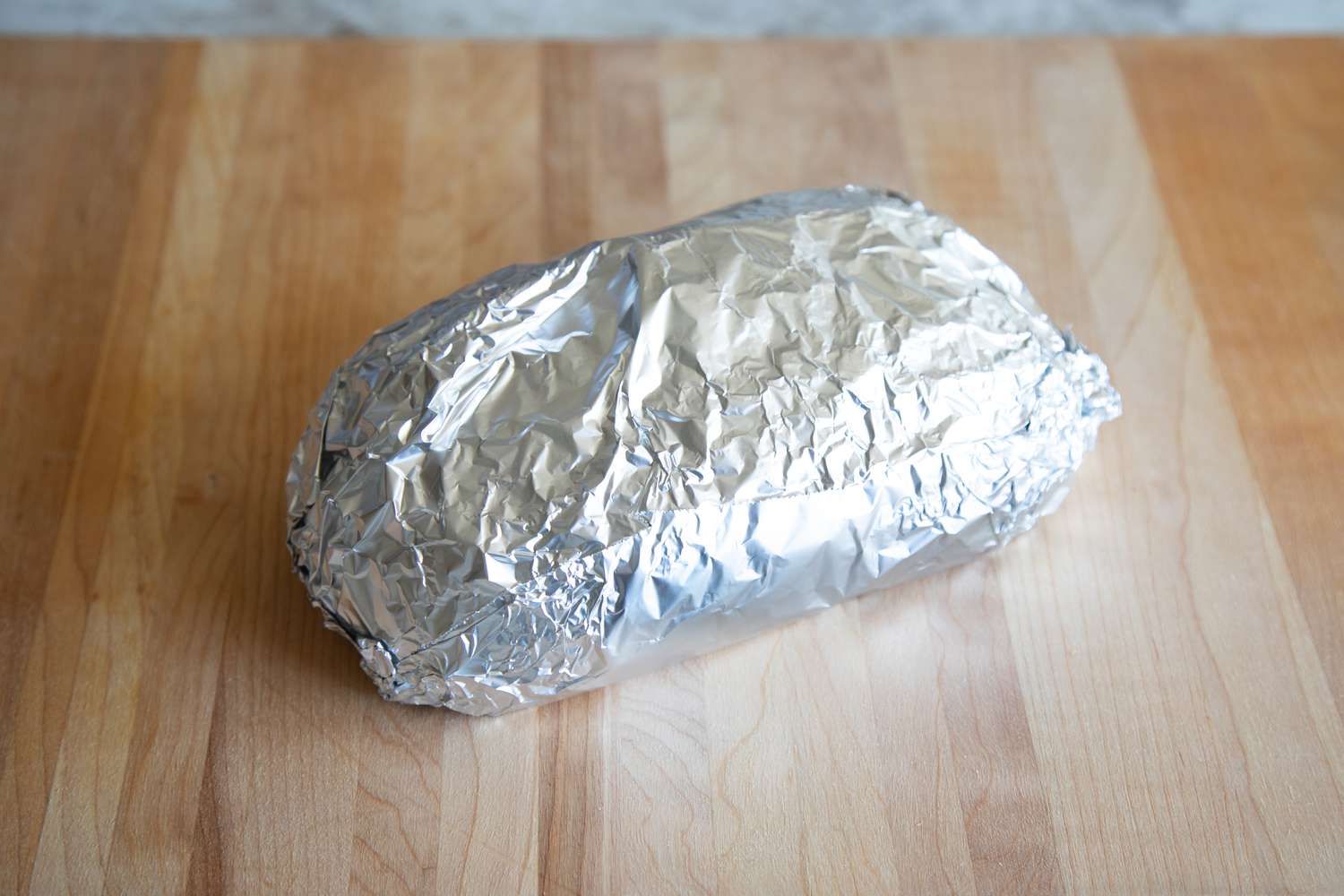 Bread loaf wrapped in aluminum foil